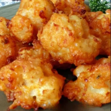 Crispy cheddar fried cauliflower bites served on a plate