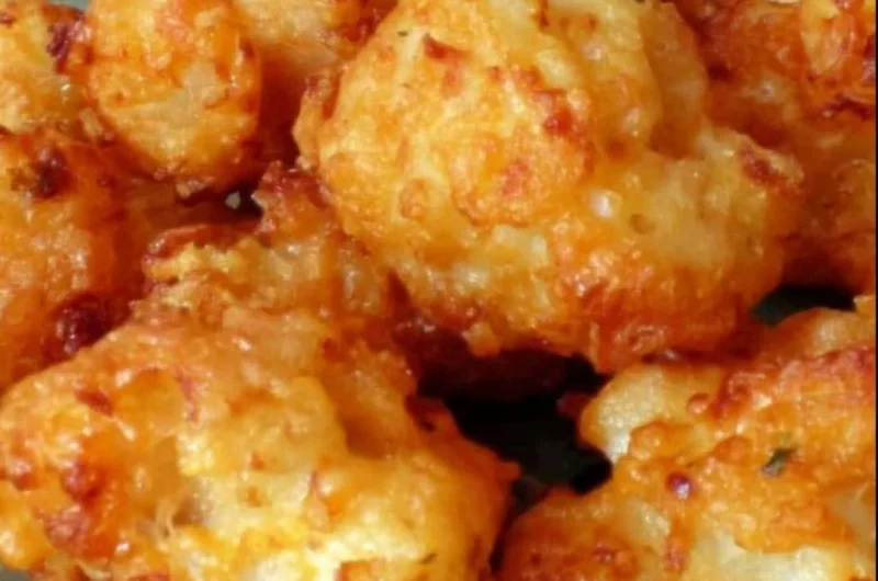 Crispy cheddar fried cauliflower bites served on a plate