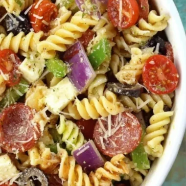 Bowl of classic pasta salad with vegetables and dressing