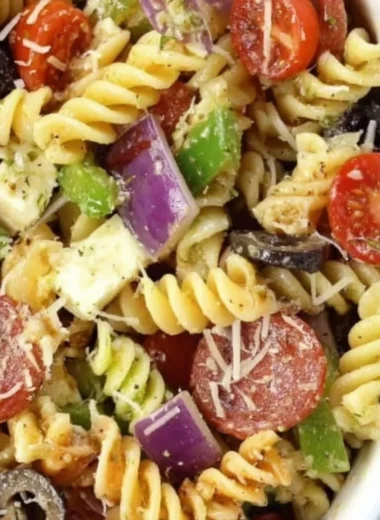 Bowl of classic pasta salad with vegetables and dressing