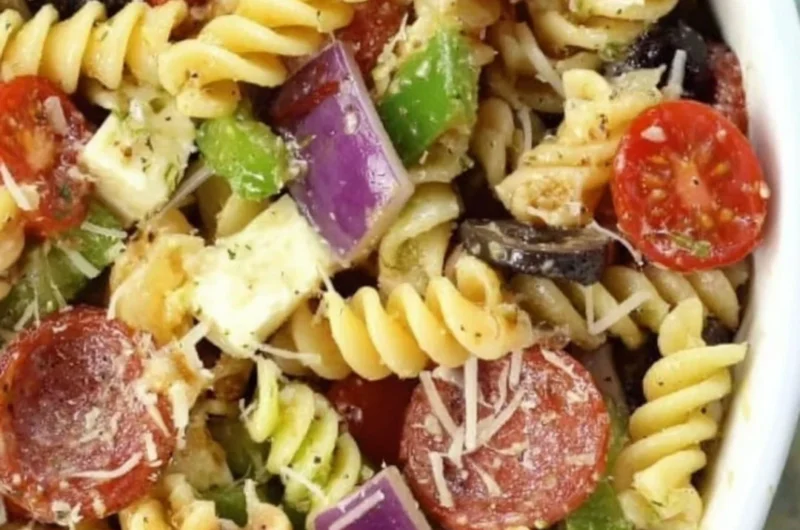 Bowl of classic pasta salad with vegetables and dressing