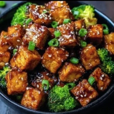 Crispy honey garlic tofu served with vegetables on a plate