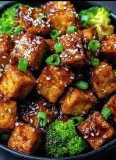 Crispy honey garlic tofu served with vegetables on a plate