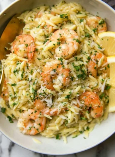 Delicious Garlic Butter Prawn Orzo served in a bowl garnished with herbs