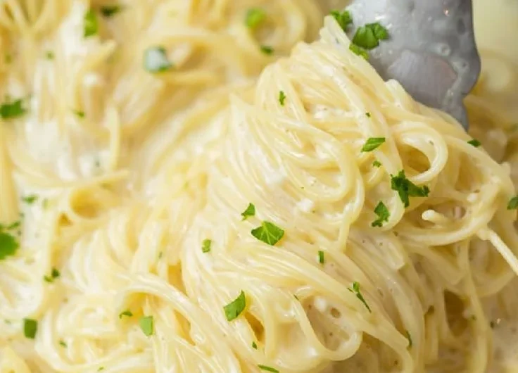 Creamy Garlic Parmesan Pasta served in a bowl with herbs and grated cheese