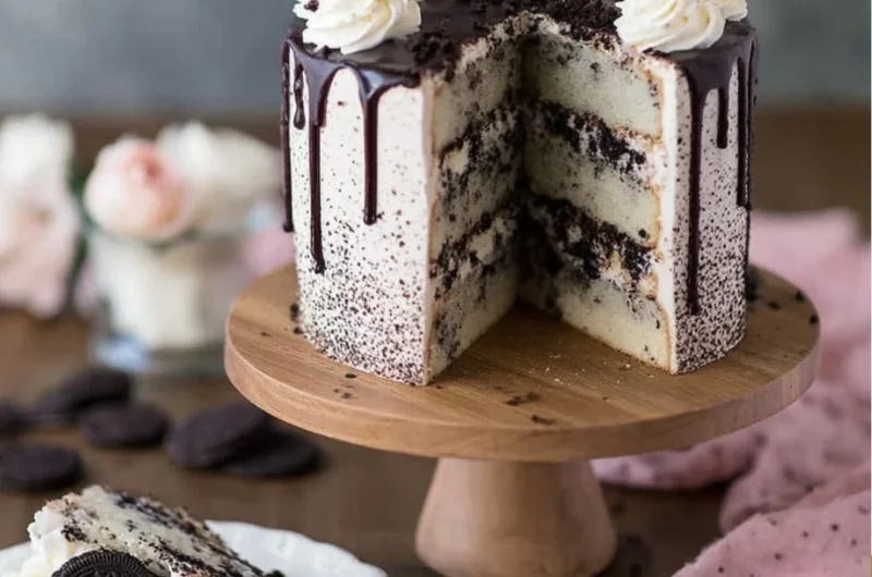 Decadent Oreo Cake topped with crumbled cookies and creamy frosting