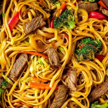 Beef stir fry with linguini served with colorful vegetables in a bowl