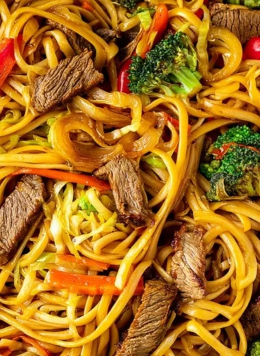 Beef stir fry with linguini served with colorful vegetables in a bowl