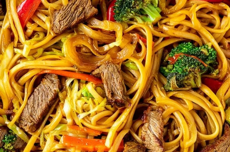 Beef stir fry with linguini served with colorful vegetables in a bowl