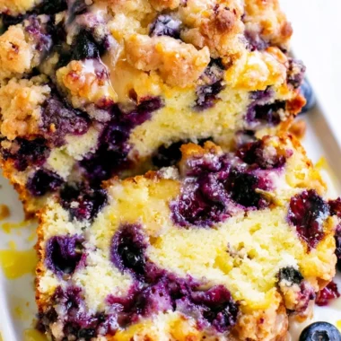 Freshly baked Blueberry Lemon Loaf with blueberries and lemon zest.