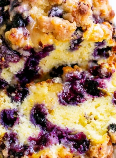 Freshly baked Blueberry Lemon Loaf with blueberries and lemon zest.