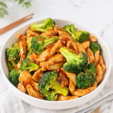 Chinese chicken and broccoli stir fry served in a bowl with chopsticks