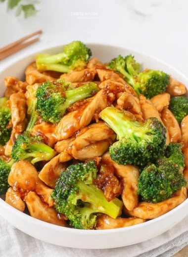 Chinese chicken and broccoli stir fry served in a bowl with chopsticks
