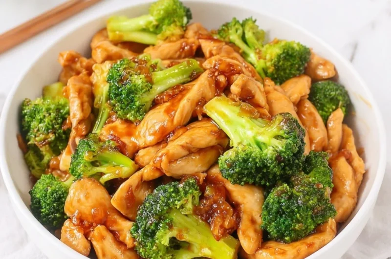 Chinese chicken and broccoli stir fry served in a bowl with chopsticks