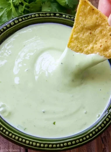 Delicious cilantro lime cream served in a bowl, garnished with fresh cilantro leaves