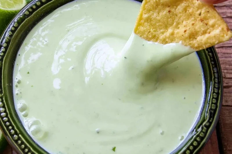 Delicious cilantro lime cream served in a bowl, garnished with fresh cilantro leaves