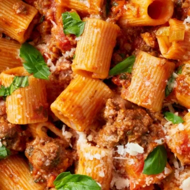 A pot of simmering classic Bolognese sauce with fresh ingredients.