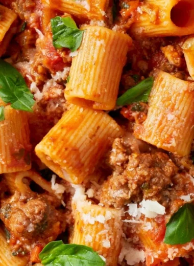 A pot of simmering classic Bolognese sauce with fresh ingredients.