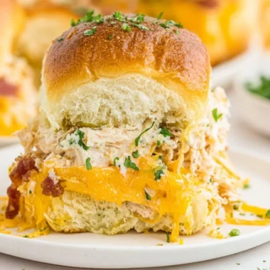 Delicious crack chicken sliders served on a platter with toppings.