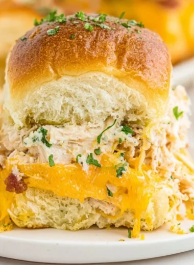 Delicious crack chicken sliders served on a platter with toppings.