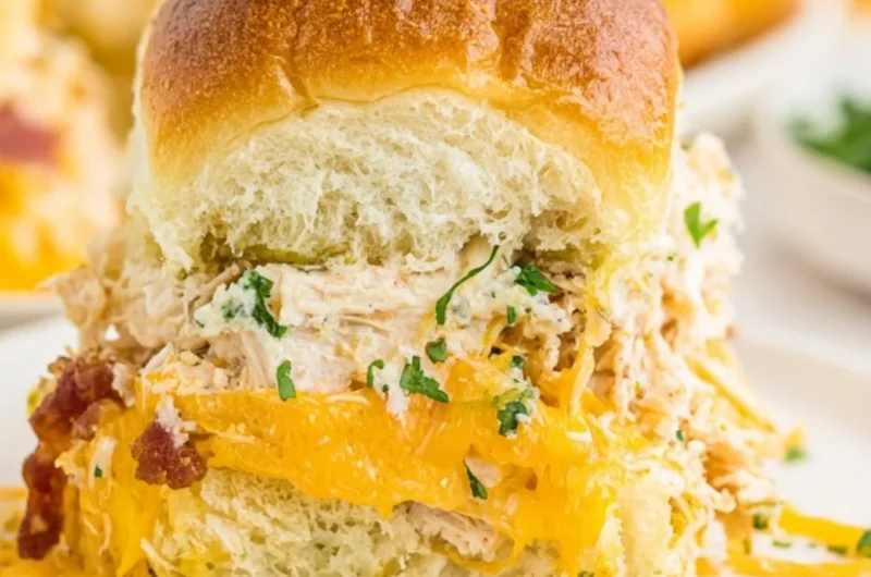Delicious crack chicken sliders served on a platter with toppings.