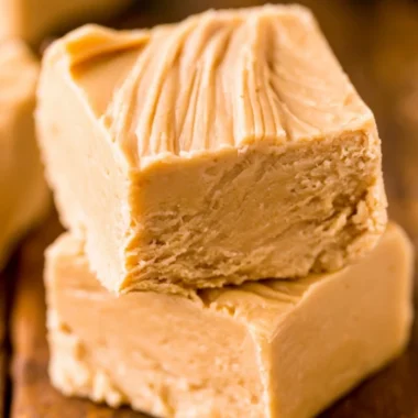 Delicious easy peanut butter fudge cut into squares on a plate