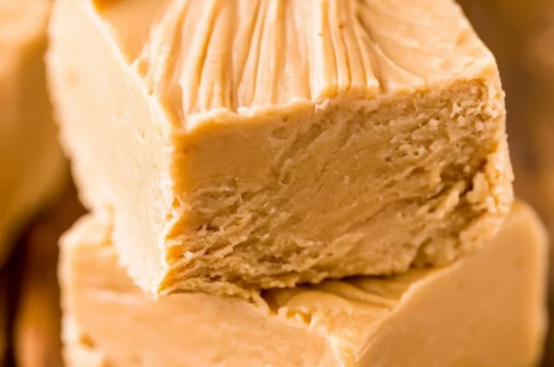 Delicious easy peanut butter fudge cut into squares on a plate
