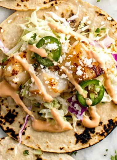 Delicious fish tacos with fresh toppings and garnishes.