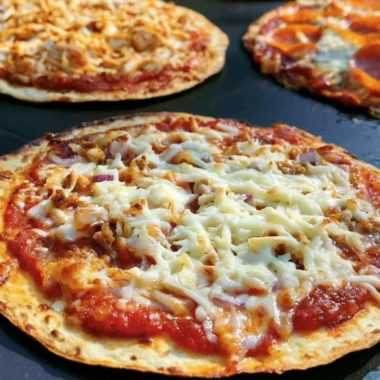Delicious homemade griddle pizza topped with fresh ingredients.