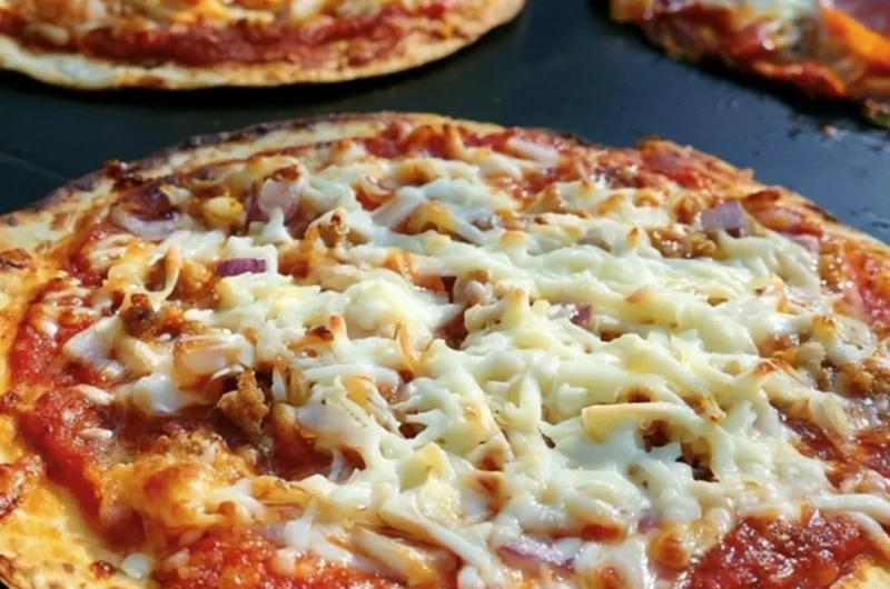 Delicious homemade griddle pizza topped with fresh ingredients.