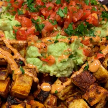High protein power bowl with quinoa, beans, vegetables, and avocado for a nutritious meal.