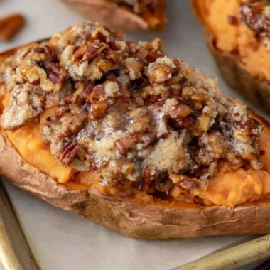 Twice baked sweet potatoes topped with pecan pie filling and nuts.