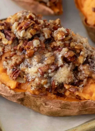 Twice baked sweet potatoes topped with pecan pie filling and nuts.