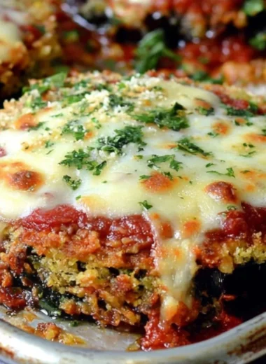 Delicious Sheet Pan Eggplant Parmesan ready to serve on a wooden table