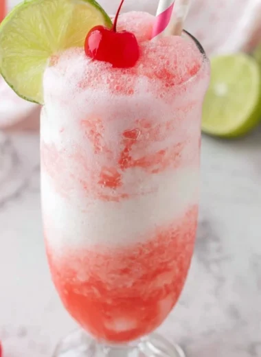 Shirley Temple Ice Cream Float served in a glass with cherry on top