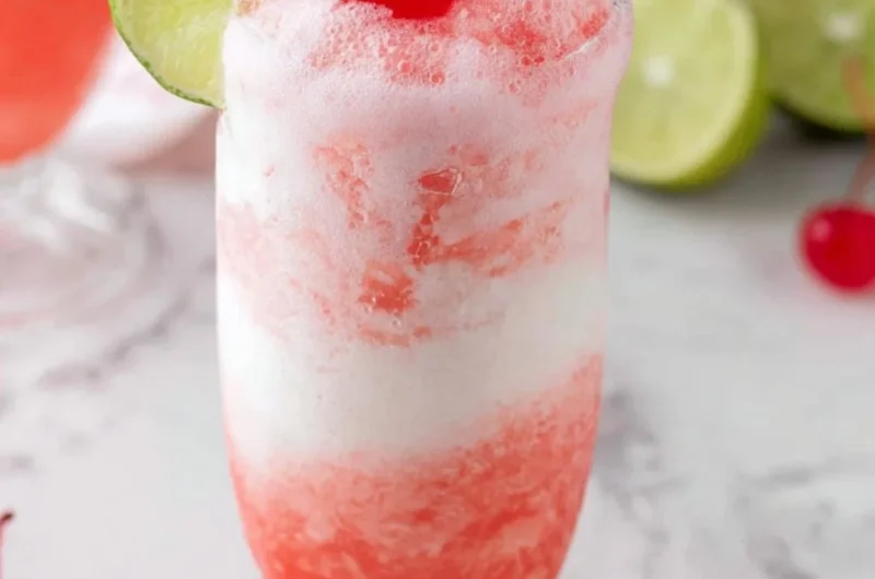 Shirley Temple Ice Cream Float served in a glass with cherry on top