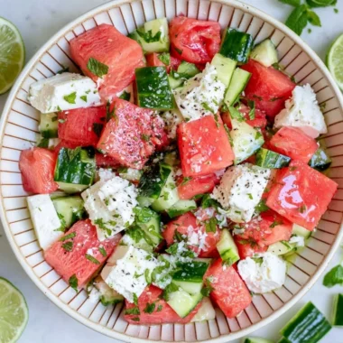 Colorful watermelon cucumber feta salad in a bowl, garnished and ready to serve