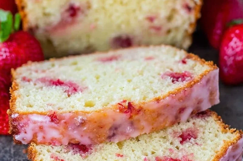 Delicious strawberry pound cake topped with fresh strawberries and whipped cream