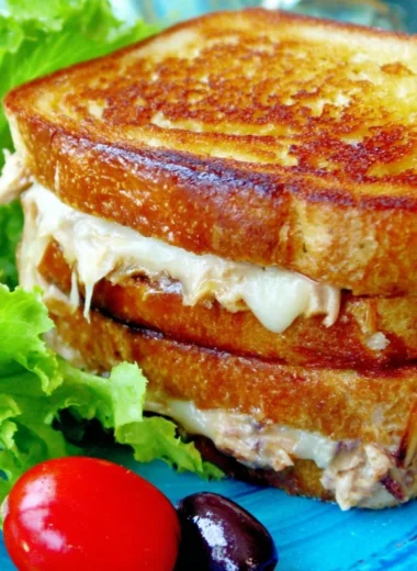 Delicious tuna melt on toasted bread with cheese and herbs