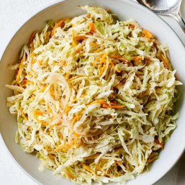 Bowl of fresh vineger coleslaw with vibrant vegetables