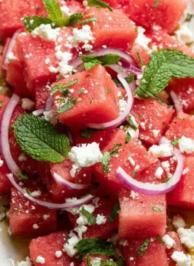 A vibrant watermelon feta salad garnished with fresh mint leaves
