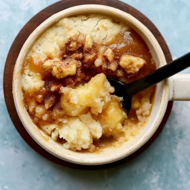 Delicious homemade apple mug cake topped with cinnamon and apple slices