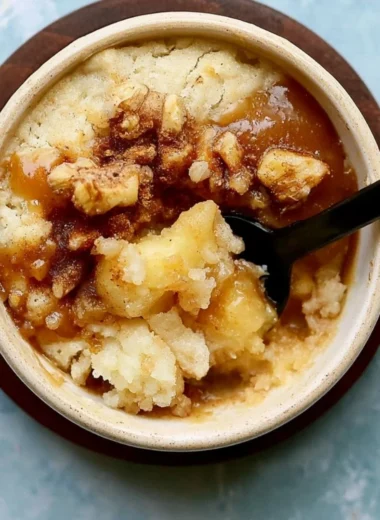 Delicious homemade apple mug cake topped with cinnamon and apple slices