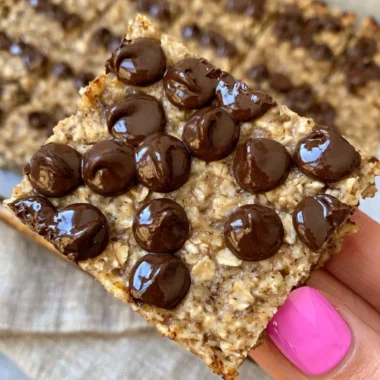 Banana bread oatmeal bars on a wooden table, healthy meal prep snacks.