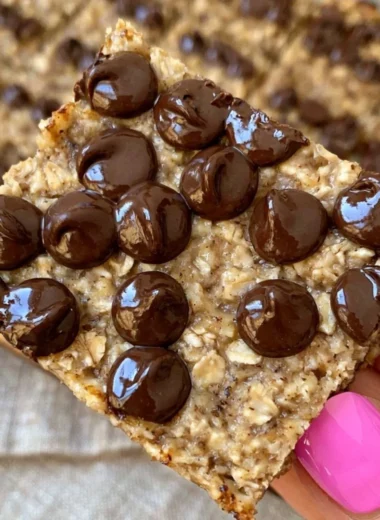 Banana bread oatmeal bars on a wooden table, healthy meal prep snacks.