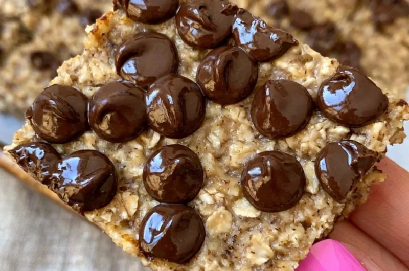 Banana bread oatmeal bars on a wooden table, healthy meal prep snacks.