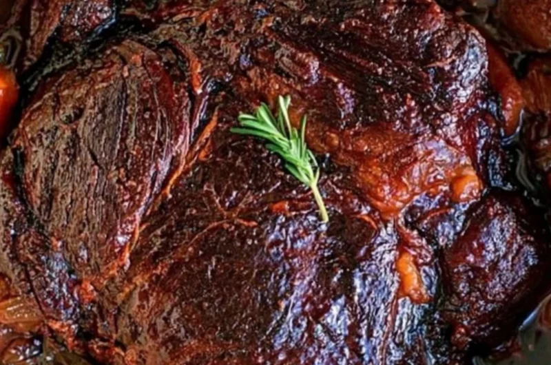 Deliciously prepared beef chuck roast served with vegetables and herbs