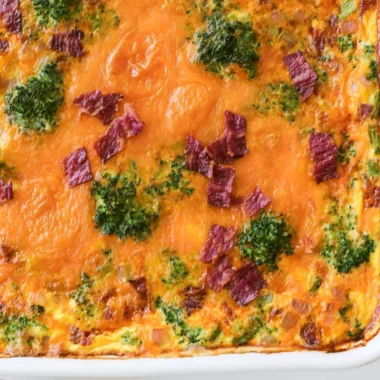 Broccoli Cheddar Egg Bake with Turkey Bacon served in a dish