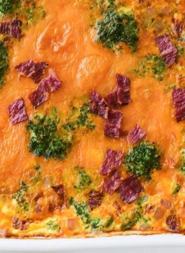 Broccoli Cheddar Egg Bake with Turkey Bacon served in a dish