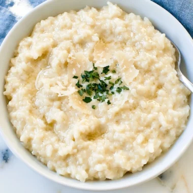 Creamy Parmesan Risotto topped with fresh parsley and parmesan cheese